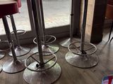 four stools sitting in front of a table in a restaurant