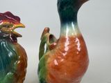 two vases that are sitting side by side on a table