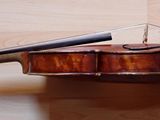a violin that is sitting on a wooden floor
