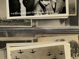 several black and white photos of people and airplanes in a display case