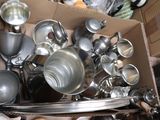 a cardboard box full of pots and pans on the floor