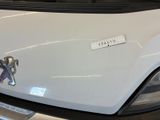 a white car with a sticker on it ' s hood