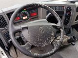 steering wheel and dashboard of a truck with dirt all over it
