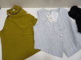 two shirts are sitting on a table next to a pair of pants