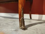 a wooden table with a carved top and a wooden base