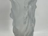 a glass vase with a design on it on a table