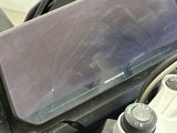 a close up of a cell phone on the dashboard of a motorcycle