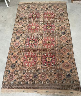 a large antique persian rug with a red and blue design