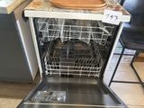 a dishwasher that is sitting in the middle of a kitchen
