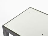 a glass table with a metal base and a glass top