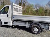 a white truck that is parked in the gravel