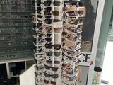 a display of sunglasses in a store with a lot of them