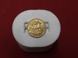a gold coin sitting on top of a white box
