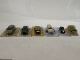 several toy cars are lined up in plastic bags on a white surface