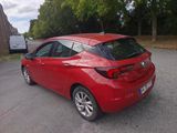 a red car that is parked on the side of the road