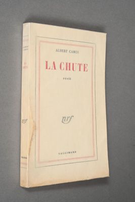 an old book sitting on top of a table on a gray surface