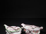 a pair of pink and white porcelain dishes with floral designs