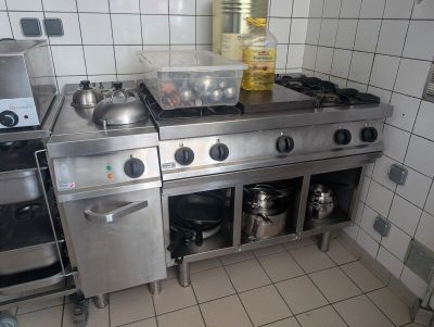 a kitchen with a stove, oven, and sink in it