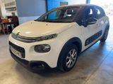 Une Citroën blanche est garée dans un garage