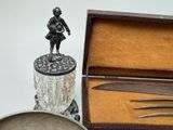 a silverware set with a figurine in a box