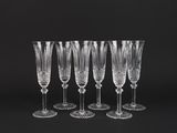 a set of six crystal wine glasses on a black background