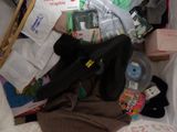 a pile of clothes and other items on a bed