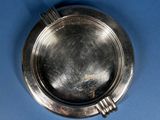 a silver plate on a blue surface with a blue background