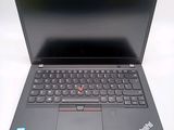 the laptop is open on a white surface with a black keyboard