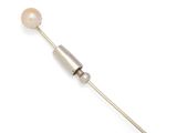 a close up of a metal needle with a pearl on it