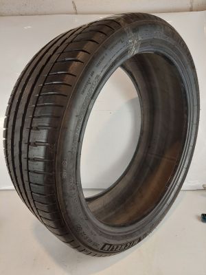 a close up of a tire on a table next to a screw