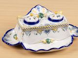 a blue and white plate with a blue and yellow lid