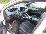 the interior of a white car with black leather seats and a steering wheel