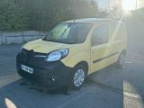 a small yellow van that is parked in a parking lot