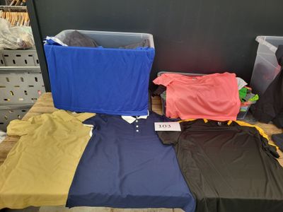 a lot of clothes on a table in a store