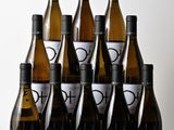 six bottles of wine sitting on top of a wooden table