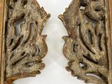two pieces of wood that have been carved to look like leaves