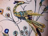 painting of a bird on a plate with flowers and blue flowers