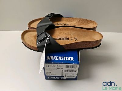 pair of birkenstock sandals on top of a box on a table