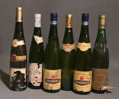 several bottles of wine are lined up in a row on a table
