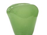 a green glass vase sitting on top of a white table