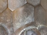 a close up of a metal object with a face on it