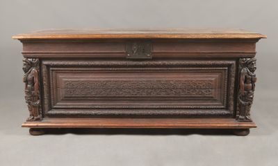 un vieux coffre en bois avec des gravures et des sculptures sur les côtés