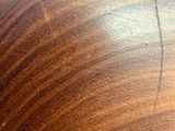 a close up of a wooden table with a brown surface