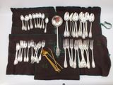 a lot of spoons and forks laid out on the table