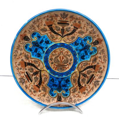 a blue and brown plate with a design on it