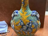 a vase that is sitting on a table with a pair of scissors