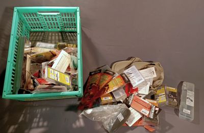 a green basket full of food next to a green basket filled with food