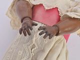 a statue of a woman in a dress holding a piece of cloth