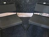 two chairs that are sitting in the corner of a room