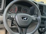 a steering wheel and dashboard of a truck in a parking lot